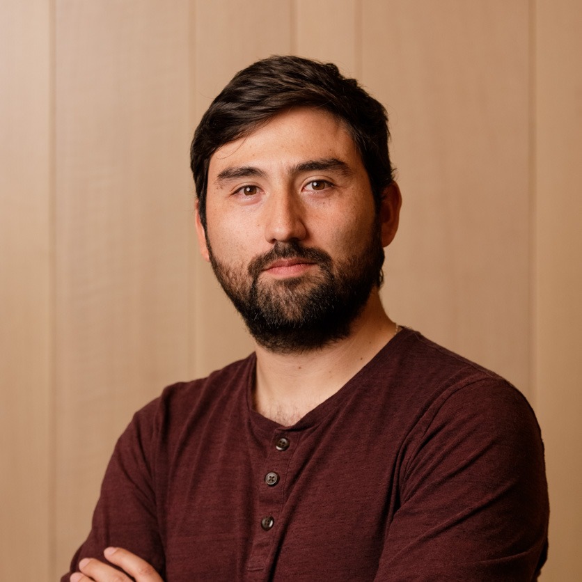 Headshot against a wooden background