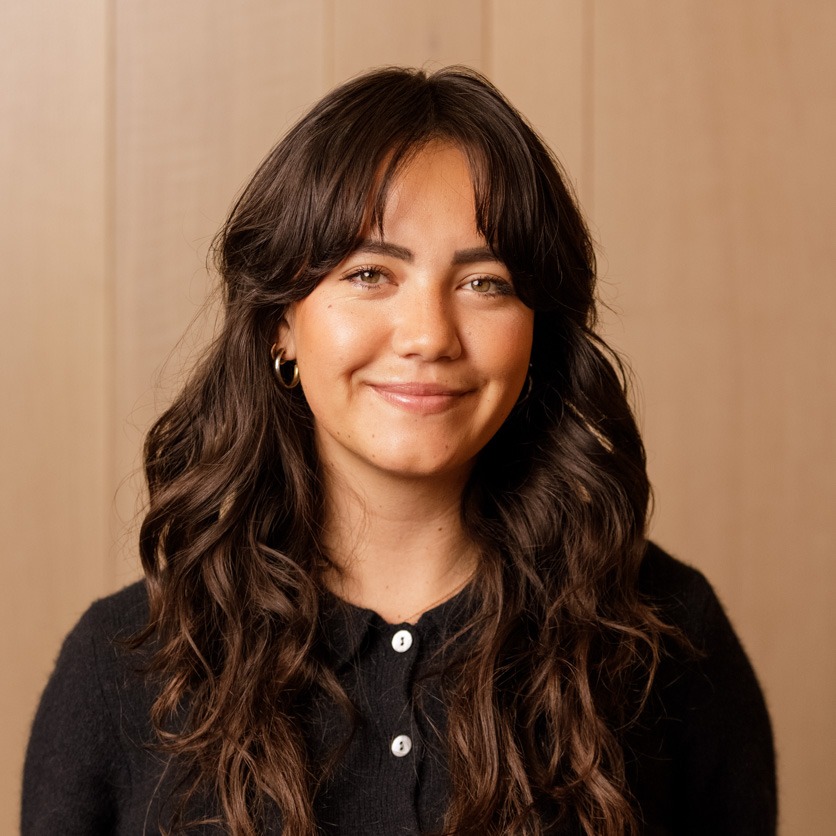 Sydney headshot on a wooden background